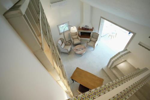 an overhead view of a living room with chairs and a table at Praialonga Suites with Pool and Garden in Le Castella