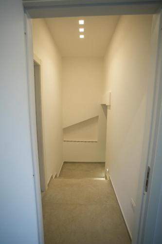 an empty hallway with a staircase in a room at Praialonga Suites with Pool and Garden in Le Castella