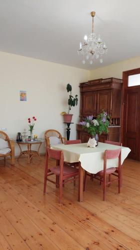 a dining room with a table and chairs and a chandelier at Guesthouse ''Door'' in Sighnaghi in Sighnaghi