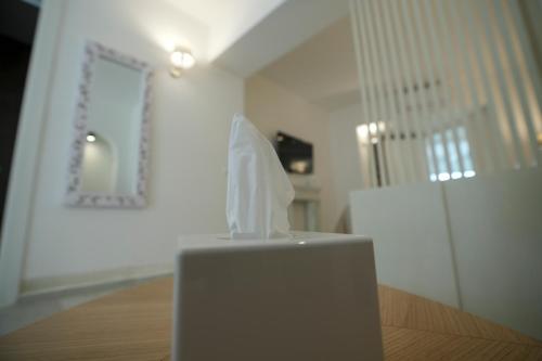a white object sitting on a table in a room at Praialonga Suites with Pool and Garden in Le Castella