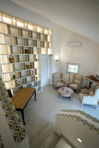 a living room with a couch and a table at Praialonga Suites with Pool and Garden in Le Castella