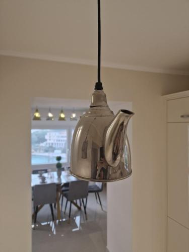 a silver pendant light hanging in a kitchen at Samos Endless Blue in Samos
