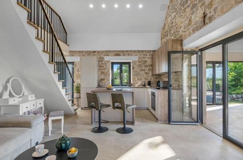 a kitchen and living room with a stone wall at Vila Anita in Trbounje