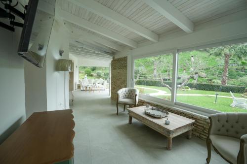 a living room with a couch and a table at Praialonga Suites with Pool and Garden in Le Castella