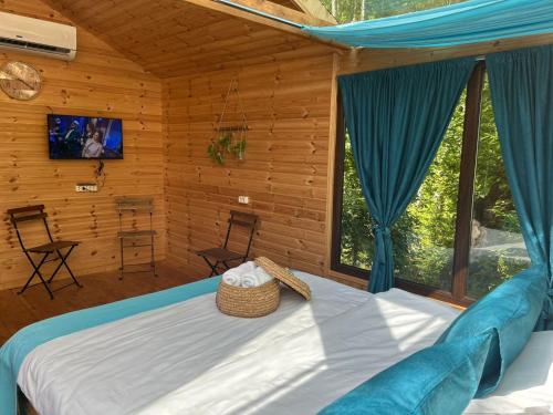 a bedroom with a bed and a large window at SkyDoor_ცისკარი in Batumi