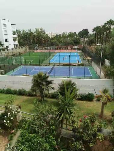 a tennis court with two tennis courts at PLAYA DEL PACHA MARINA SMIR in Fnidek