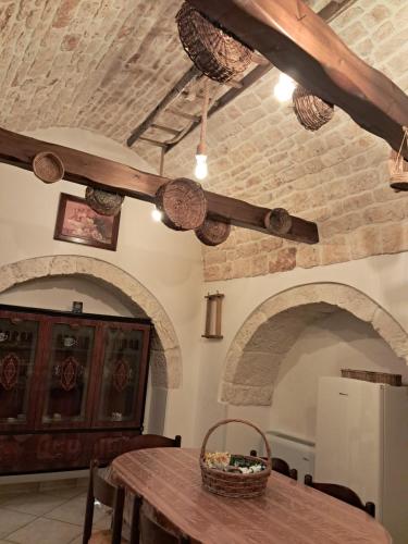 a dining room with a table with a basket on it at Trulli: La pace dei sensi in Alberobello