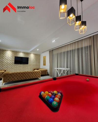 a billiard room with a red pool table at Villa Prestige N116 in Arbatache