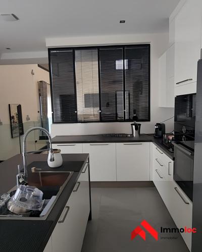 a kitchen with white cabinets and a sink and a window at Villa Prestige N116 in Arbatache