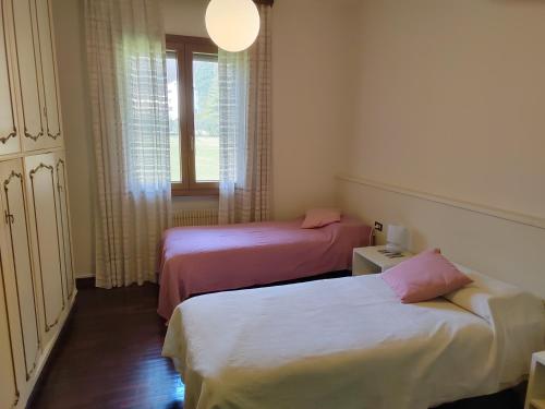 a room with two beds and a window at Bed and breakfast santa felicita in Borso del Grappa