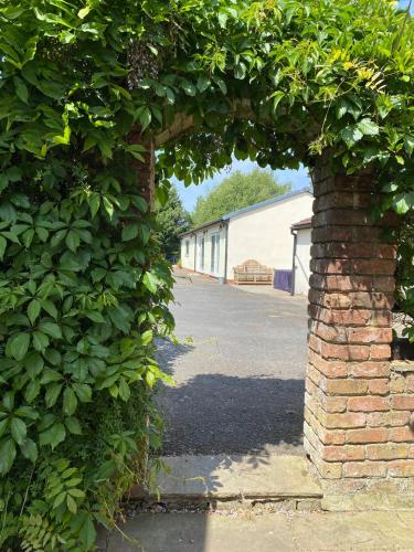 an archway with a brick wall and a street at Luxury Country Lodge in Bretherton - Sleeps 4 in Bretherton