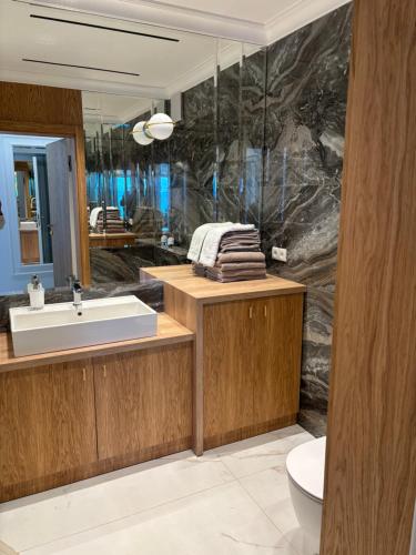 a bathroom with a sink and a mirror at Solaris Darłówko Premium Emilia Strupiechowska in Darłowo