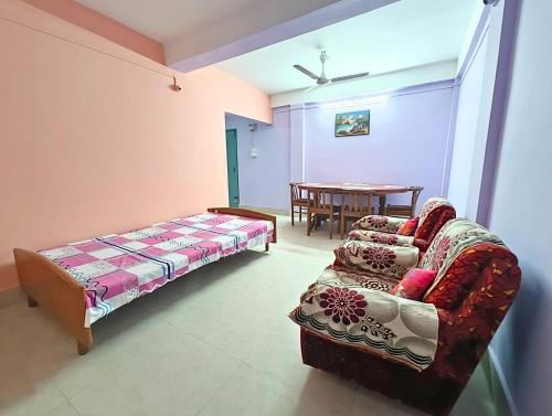 a living room with a couch and a table at Entire 1BHK & 2BHK private apartments with personal kitchen, 767ooo54oo, TAJ RESIDENCY Holiday Homestay in Jorhat