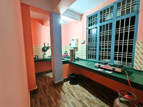 a bathroom with pink walls and a large window at Entire 1BHK & 2BHK private apartments with personal kitchen, 767ooo54oo, TAJ RESIDENCY Holiday Homestay in Jorhat