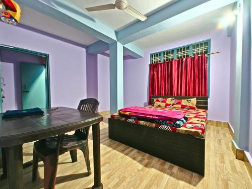 a bedroom with a bed and a table with a desk at Entire 1BHK & 2BHK private apartments with personal kitchen, 767ooo54oo, TAJ RESIDENCY Holiday Homestay in Jorhat