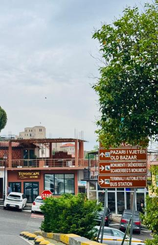 a street with street signs in front of a building at Kruja Townscape Rooms in Krujë