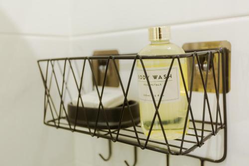 a shelf with a bottle of oil and soap at Accra Luxury Apartments @ The Lennox in Accra