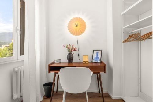 a desk in a room with a white chair at Castello Blu Suite in Sesto Fiorentino