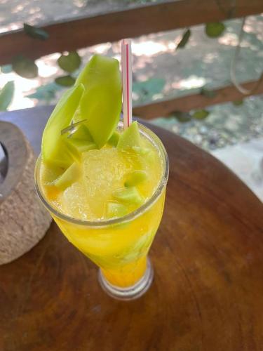 a drink sitting on a wooden table at Casa Danam in Santa Marta