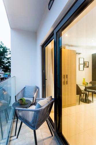 a balcony with a table and chairs and a room at Accra Luxury Apartments @ The Lennox in Accra