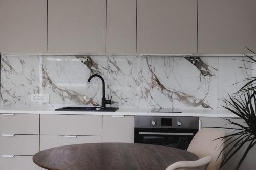 a kitchen with a marble counter top and a table at Blue alpine nest Komenda in Komenda