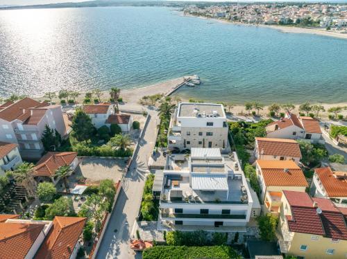 an aerial view of a town with houses and the water at Villa PUNTA DURA in Vir