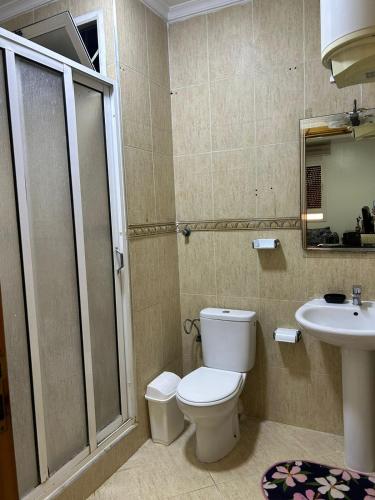 a bathroom with a toilet and a sink at Apartmentos Al Wahda - Oulad Mimoun - Nador in Nador