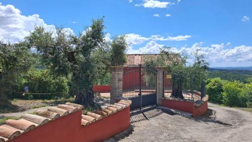 a gate to a house with a tree at Il Casaletto in Palombara Sabina