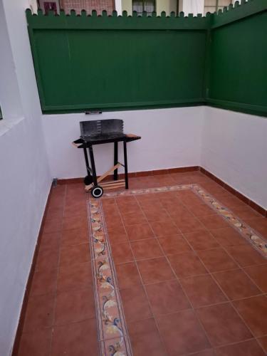 a room with a table and a green wall at FuerteSun Dunas beach in Parque Holandes