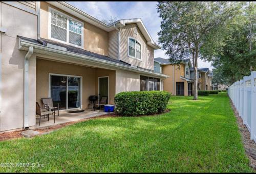 a house with a lawn in front of it at Modern Oakleaf Condo in Orange Park