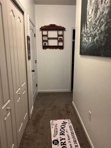 a hallway with a door and a mat on the floor at Modern Oakleaf Condo in Orange Park