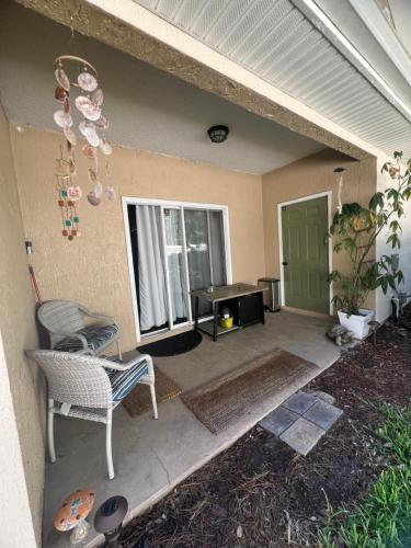 a patio with a table and a chair and a door at Modern Oakleaf Condo in Orange Park