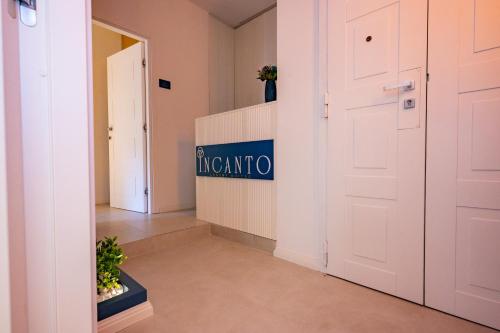a hallway with a white door and a sign that reads invariatio at Incanto in Cosenza