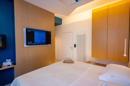 a bedroom with a bed and a flat screen tv at Incanto in Cosenza