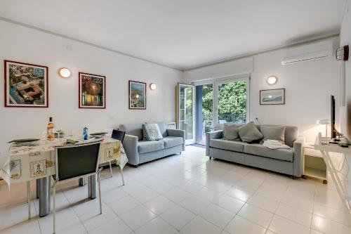 a living room with two couches and a table at Residenza Lago D'Argento - Happy Rentals in Riva del Garda