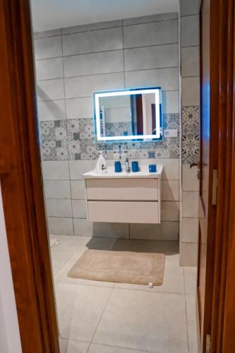 a bathroom with a sink and a mirror at Prestige Home Comfort & Elegance in Draria