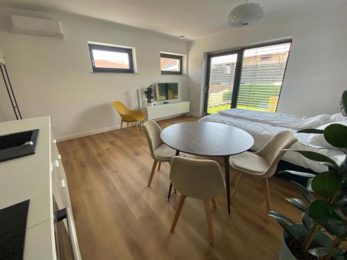 a bedroom with a bed and a table and chairs at Green alpine nest Komenda in Komenda