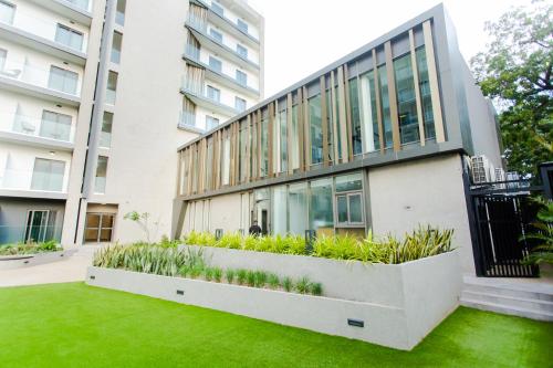 an apartment building with a garden in front of it at Accra Luxury Apartments @ The Lennox in Accra