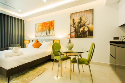 a bedroom with a bed and a table and chairs at Accra Luxury Apartments at Kass in Accra