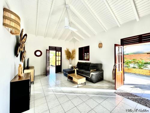a living room with a couch and a table at VILLA Ti-Colibri in Sainte-Anne