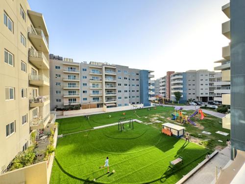 an aerial view of a park with a playground at Modern Oasis - Elegant Cave - Family Heaven - Designer's Paradise - 10 min away from Abu Dhabi Airport, Yas Island, Formula 1, Ferrari World, SeaWorld, Warner Bros World in Abu Dhabi