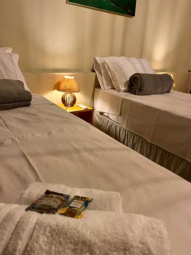 two beds sitting next to each other in a room at The Jungle, Village & Beach in Guriú