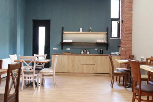 a restaurant with tables and chairs and a counter at Hotel 717 Kazbegi in Stepantsminda