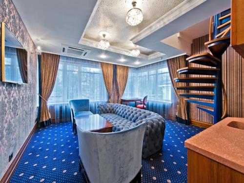 a room with a table and chairs and a book shelf at Aqua Center Apartments in Druskininkai