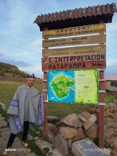a woman standing in front of a sign at Amantaní Elisa's lodge Puno in Puno
