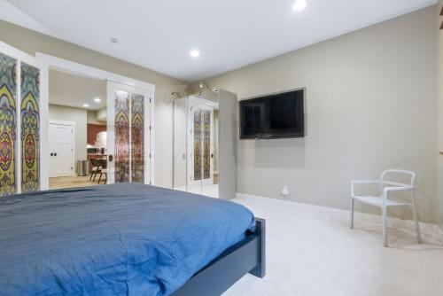 a bedroom with a bed and a tv on a wall at Two bedroom condo with steam sauna and billiards in Boulder