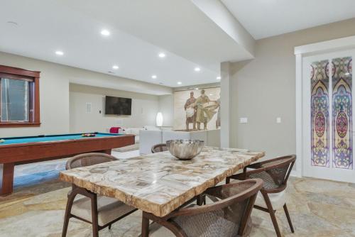 a dining room with a table and a pool table at Two bedroom condo with steam sauna and billiards in Boulder