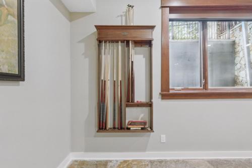 a clock on a wall next to a window at Two bedroom condo with steam sauna and billiards in Boulder