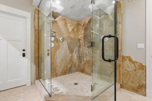 a shower with a glass door in a bathroom at Two bedroom condo with steam sauna and billiards in Boulder