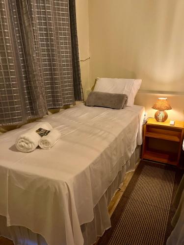 a bed with two towels on it in a room at The Jungle, Village & Beach in Guriú